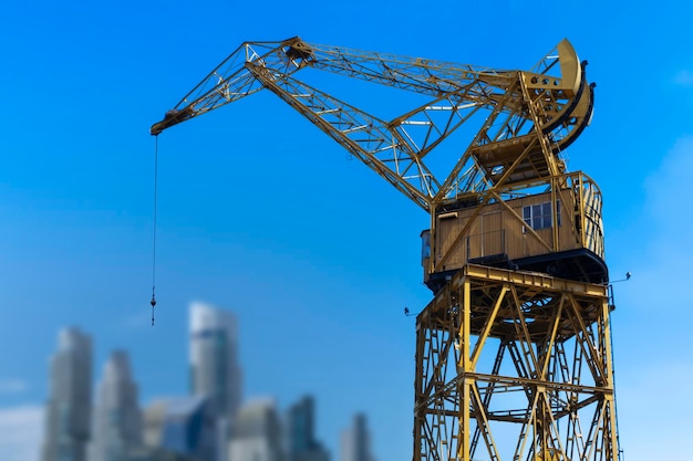 Old harbor crane on blue sky