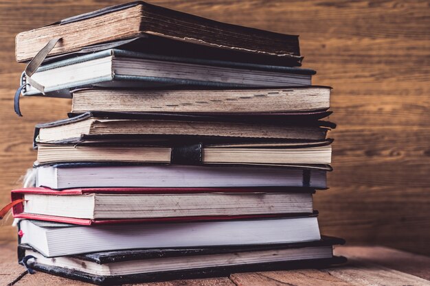 Old Hardback books on wooden table.