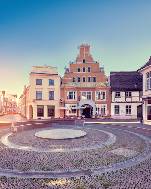 Old historic buildings Wismar Germany Empty circular square early morning