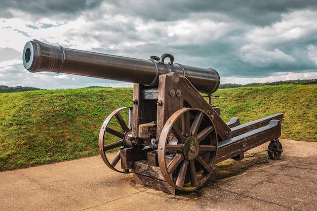 Old historical cannon storm clouds in the background