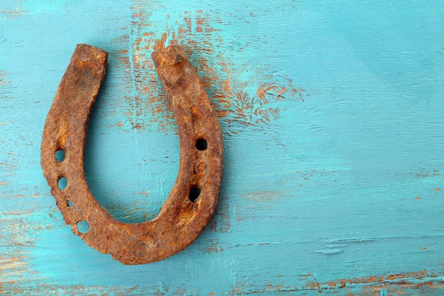 Old horse shoe on wooden background