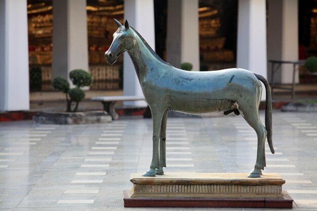 An old horse statue is in the temple.