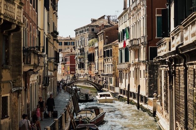 Old houses and bridge on the channel in Venice (Italy) on a sunny day in summer.