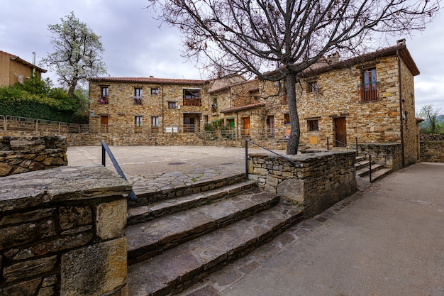 Old houses in a square in a town in the Sierra de Madrid. Horcajuelo. Madrid. Europe.