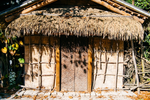 緑の葉の背景にわらの床と竹の枝で作られた古い小屋