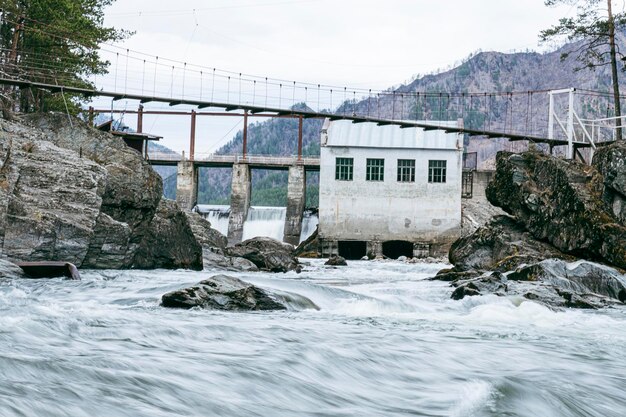 Old hydroelectric power station on Chemal river in Altai on a summer day