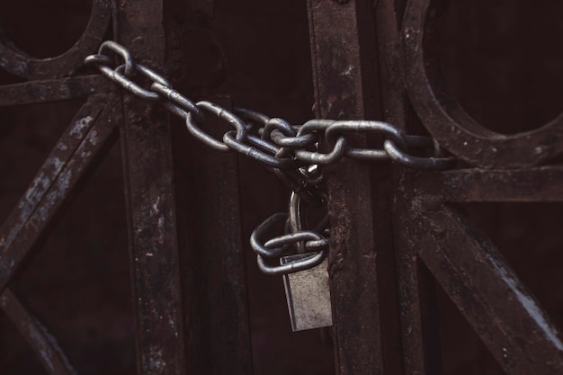 Old iron gate closed with chain and padlock