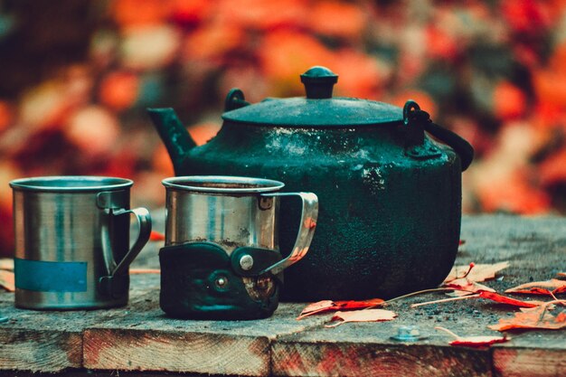 Old iron kettle and two mugs with filter