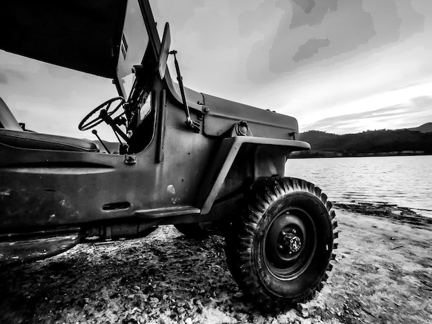 Premium Photo | Old jeep stop at lake