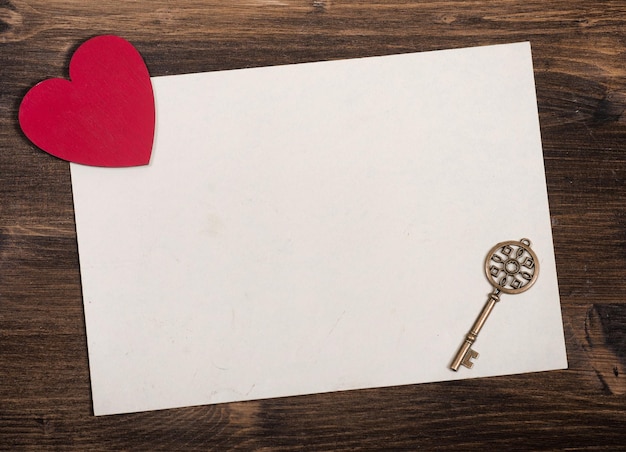 Old key decorative red heart and paper blank