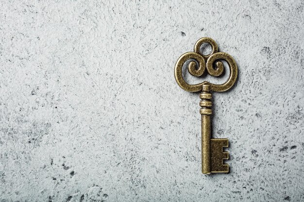 Old key on old gray concrete background