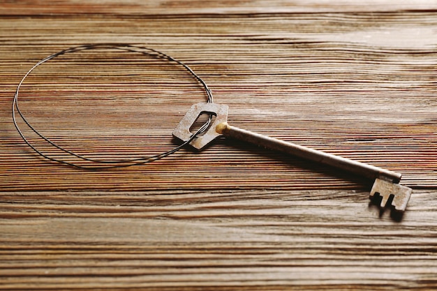 Old key on rustic wooden background