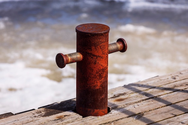 Old knecht on the dock by the ocean.