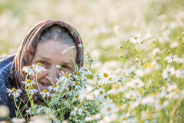 Old lady in a field with daisies Summer portrait