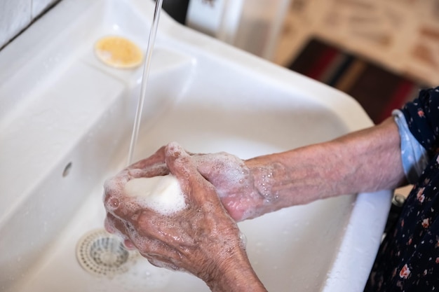 Old lady washing her hands