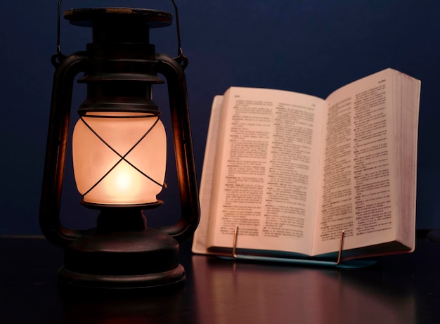 old lamp illuminates book, concept power outages