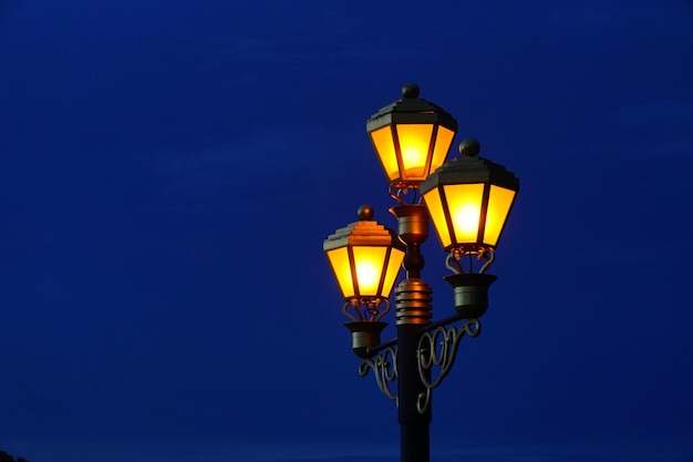 Old lamps Light pole lantern shining in sunset sky