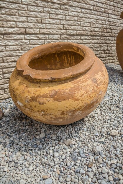 Old large jugs on a wall background