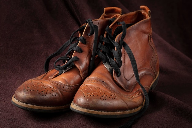 Old leather brown shoes on a dark background