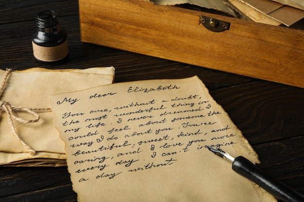 old letter with text pen and ink bottle on wooden background
