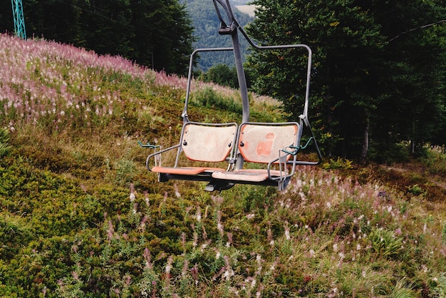 Old lift hoist at top of mountains with amazing view empty chairs chairlift travel adventure concept