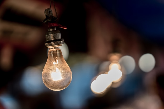 Old light bulb glowing close up