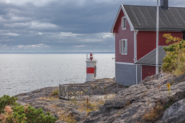 Old lighthouse and house in the Baltic Sea