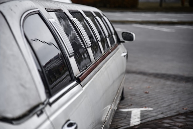 Old limousine stands in the parking lot