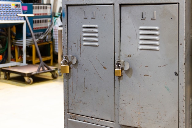 Old lockers with padlocks in industrial factory