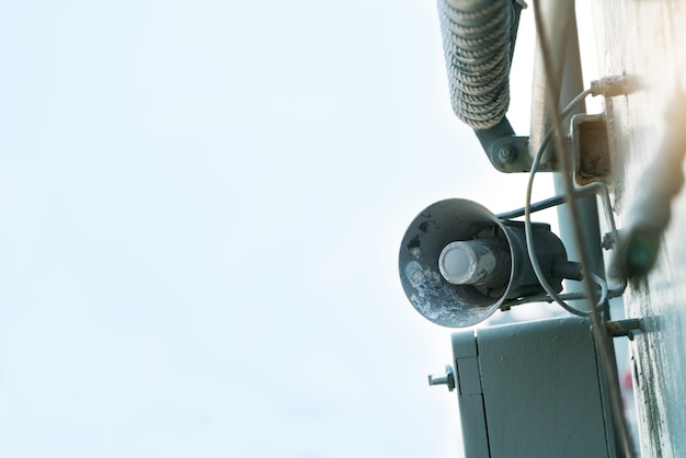 Old loud speaker megaphone on the steel metal wall background