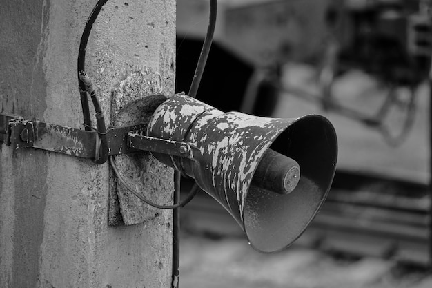 Old loudspeaker hanging pole in a black and white photo