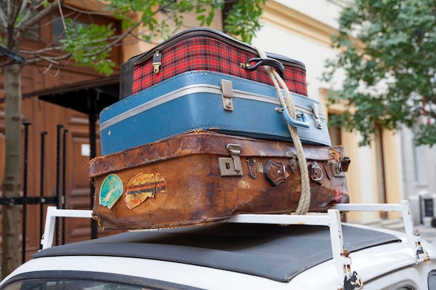 Old luggages atop of a retro car