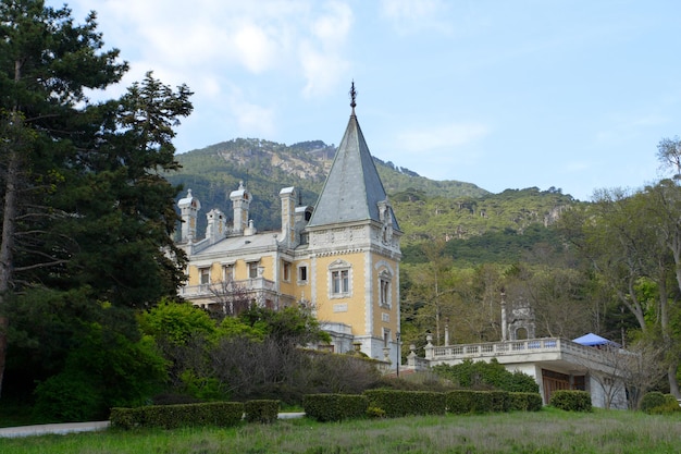 Old luxurious palace exterior with mountains in the background