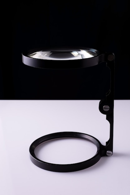 Old magnifying glass on white background loupe