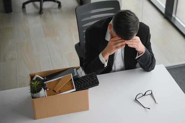 Photo old male employee in dismissal concept