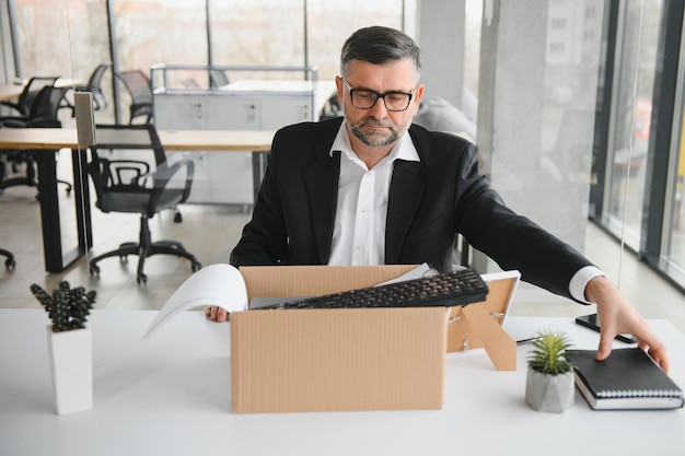 Photo old male employee in dismissal concept