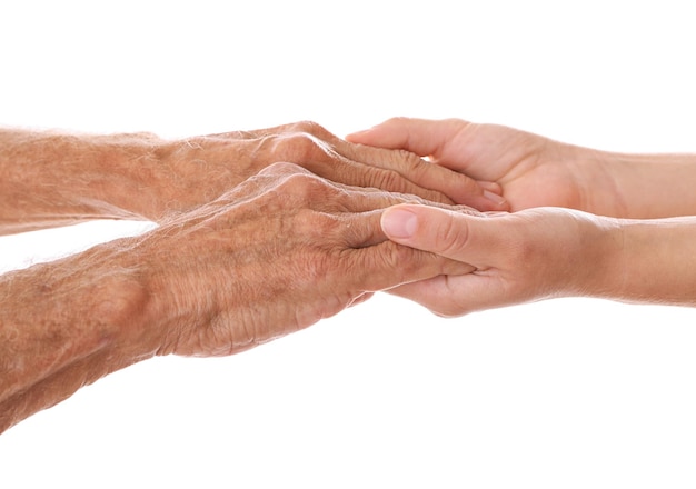 Old male and young female hands on white background