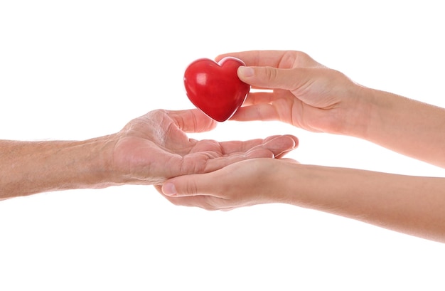 Old male and young female hands with heart figure on white background