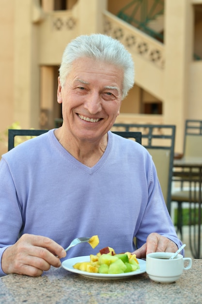 Old man at breakfast on the table