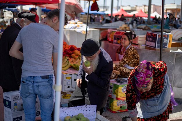 a old man buying apple from shop