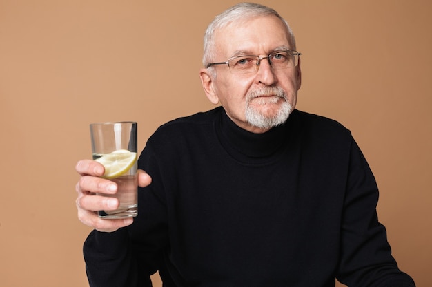 Old man drinking water portrait