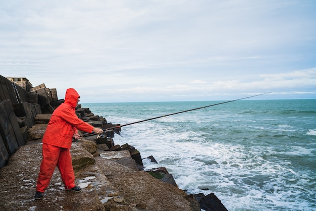 Old man fishing in the sea.