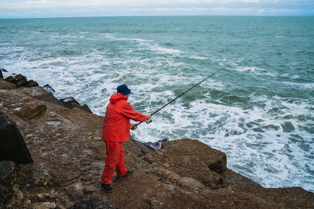 Old man fishing in the sea