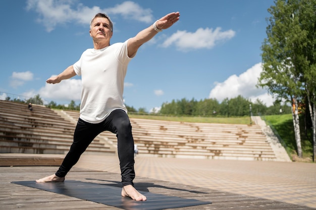 Old man grayhaired workout yoga asana sport