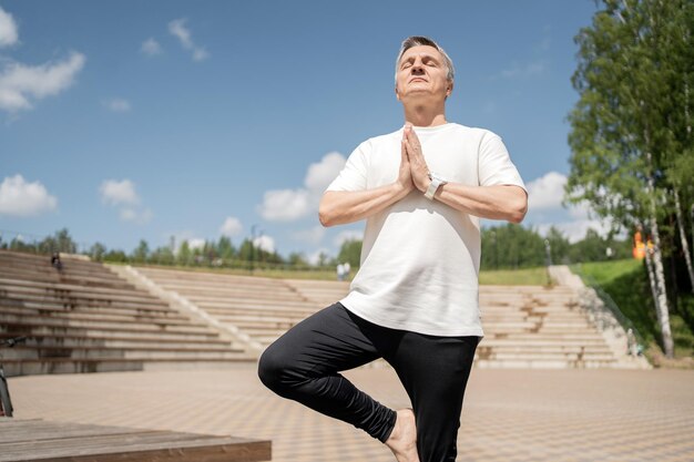 Old man grayhaired workout yoga pose asana sport