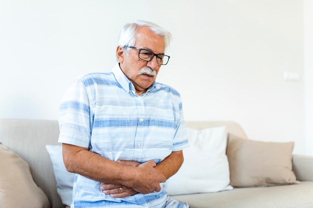 Old man having strong abdominal ache health problems Senior man with stomach pain