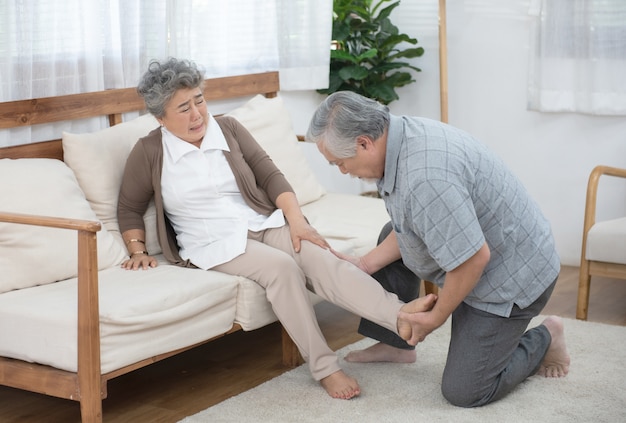 Old man look after elder woman after hurt on leg