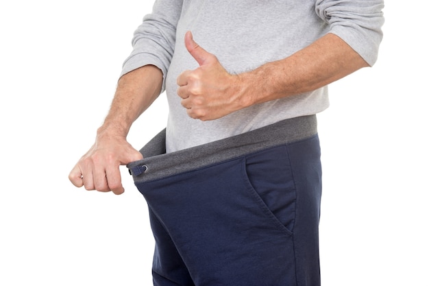 Photo old man looking in his pants and showing thumbs up