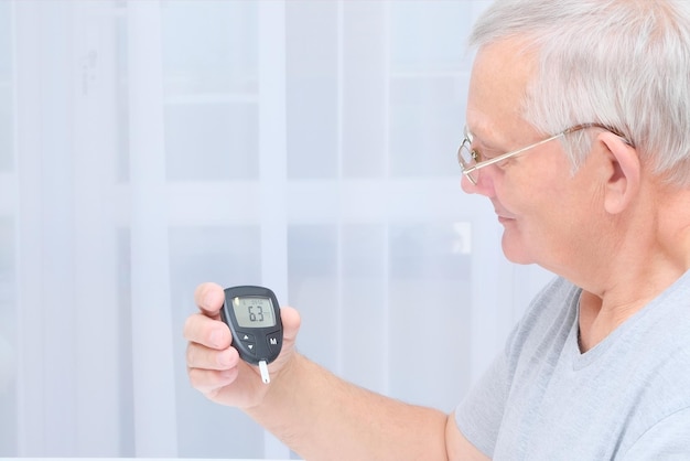 Old man measures blood sugar diabetes