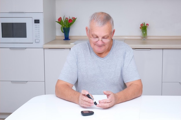 Old man measures blood sugar diabetes